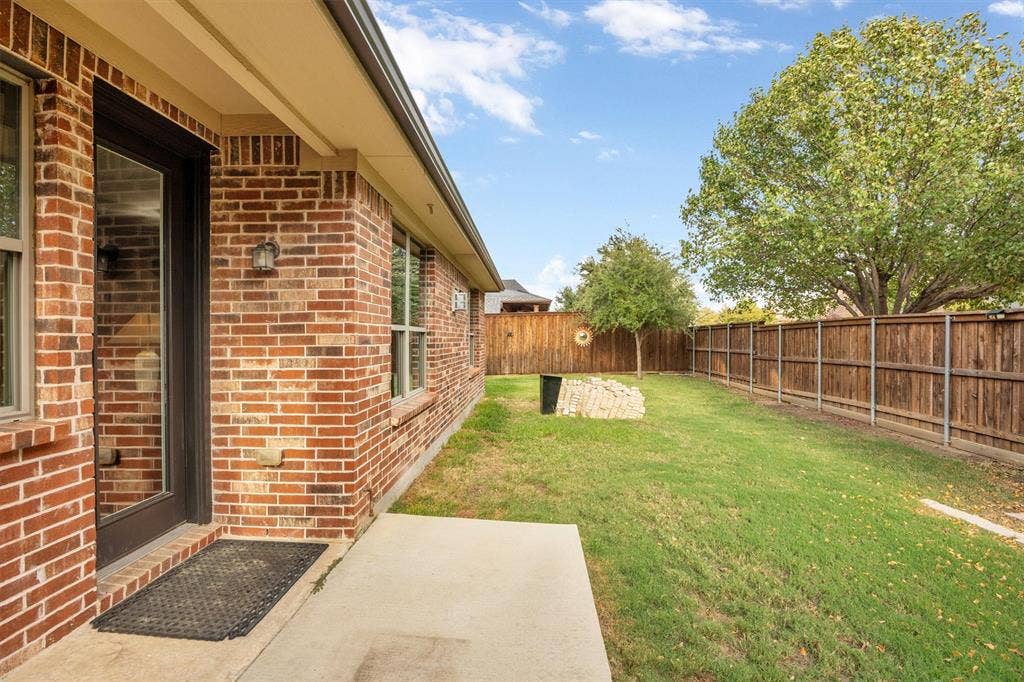 3014 Aurora Mist Drive, Little Elm, TX 75068 Big back yard has covered patio that faces east.