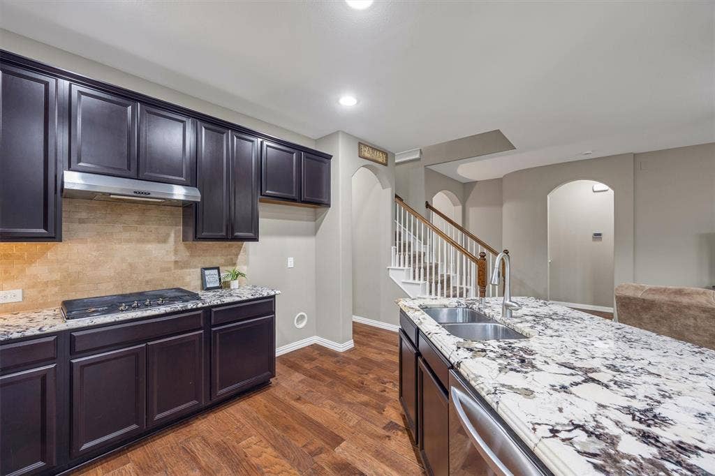 3014 Aurora Mist Drive, Little Elm, TX 75068 Gourmet kitchen featuring 5-burner gas range, stainless steel appliances and a gorgeous designer granite island.