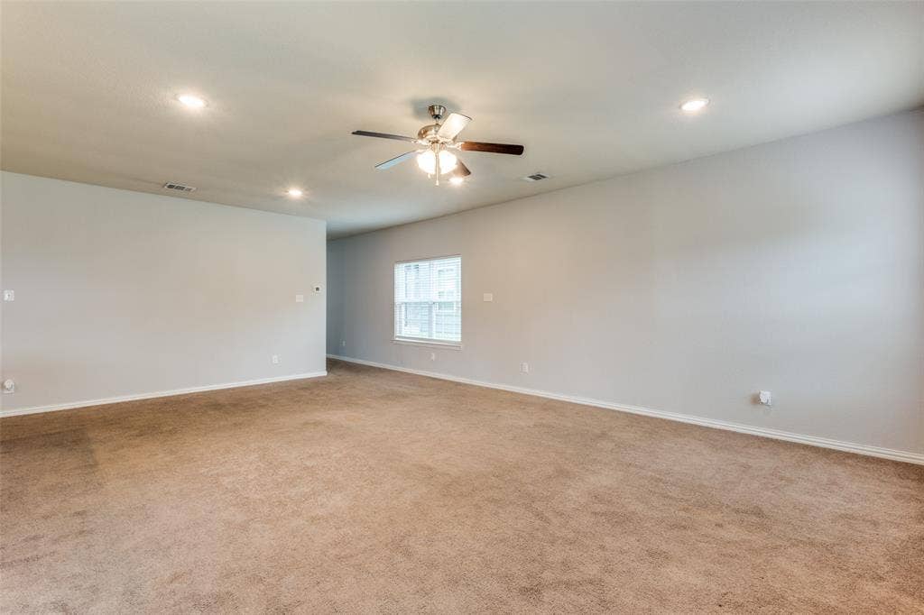 4662 Ralph Lane, Dallas, TX 75227 Spacious interior featuring neutral wall tones, wall-to-wall carpeting, recessed lighting, and a centrally mounted ceiling fan