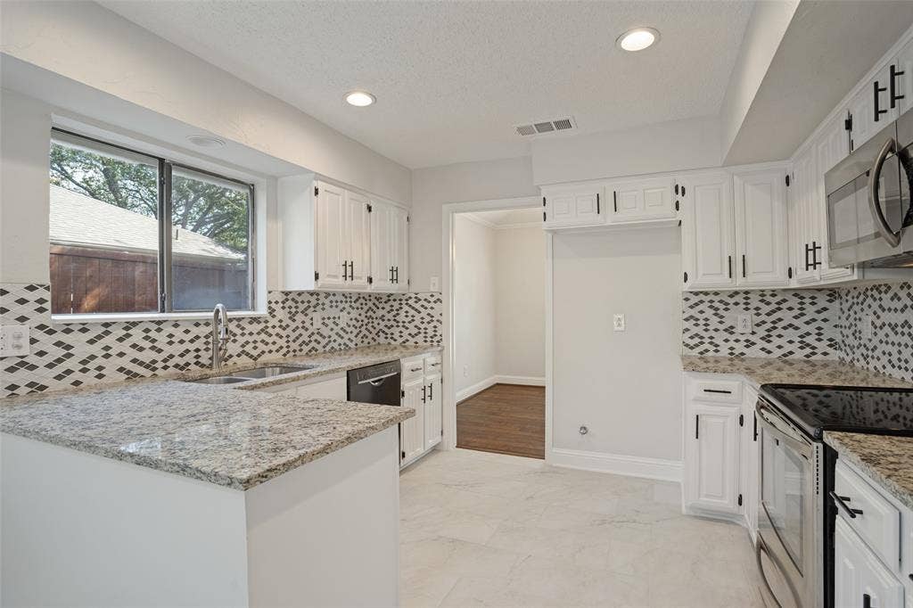 Large kitchen area with spacious countertops.