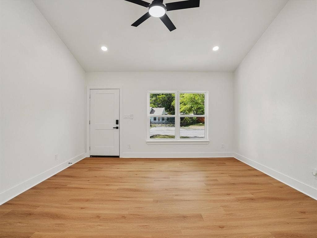 9059 Quinn Street, Dallas, TX 75217 Vaulted ceiling featuring a central matte black ceiling fan, wood-finish flooring, recessed lighting, and a multi-pane window