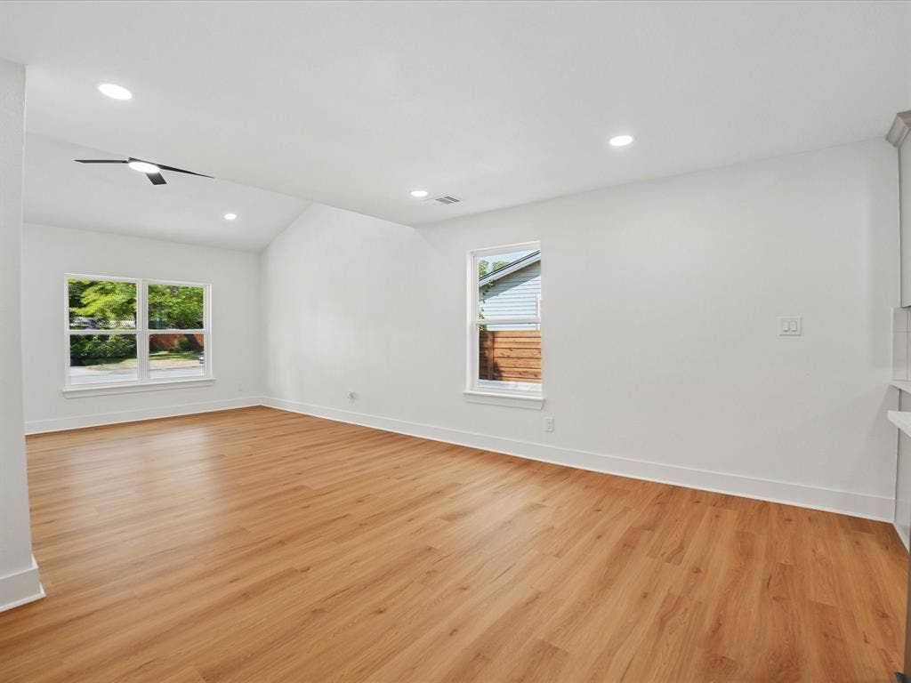 9059 Quinn Street, Dallas, TX 75217 Vaulted ceilings with recessed lighting, wood-finish flooring, and double-pane windows