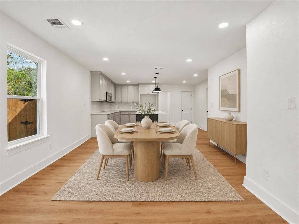 9059 Quinn Street, Dallas, TX 75217 Open-concept interior featuring light wood-finish flooring, recessed lighting, and kitchen cabinetry with a contrasting island