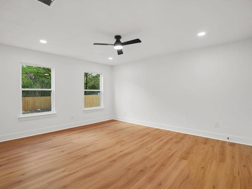 9059 Quinn Street, Dallas, TX 75217 Room featuring wood-finish flooring, recessed lighting, matte black ceiling fan, and dual pane windows