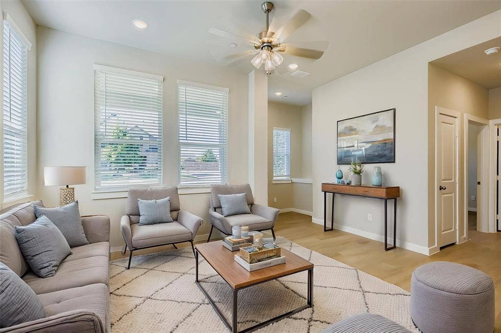 1204 Pebblebrook Drive, McKinney, TX 75071 Living area featuring wood-finish flooring, recessed lighting, a multi-blade ceiling fan with integrated lighting, and multiple windows with horizontal blinds