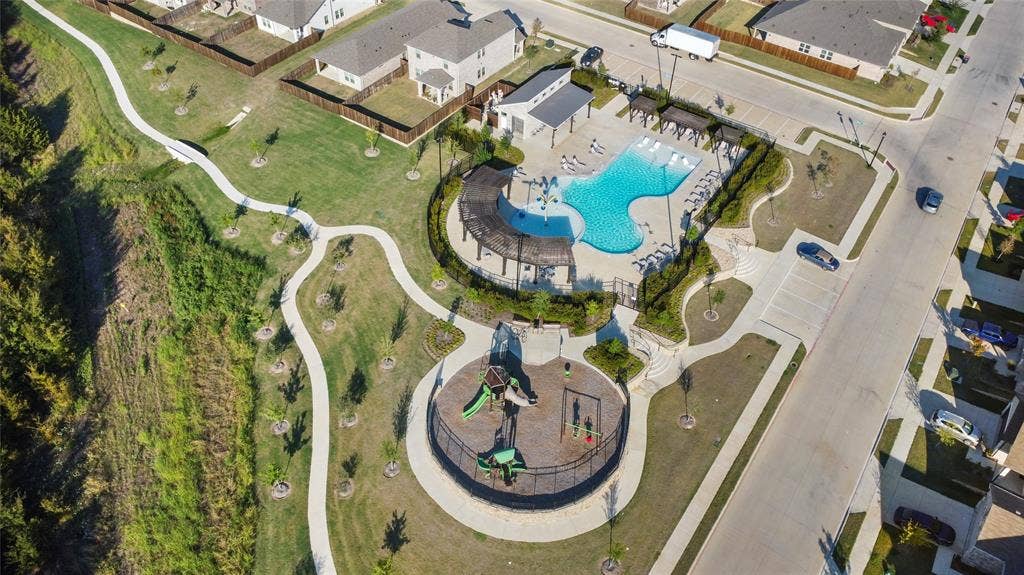 614 Martell Road, Lowry Crossing, TX 75069 Community recreational area featuring a swimming pool, pergola-covered lounge space, playground, and concrete walking paths