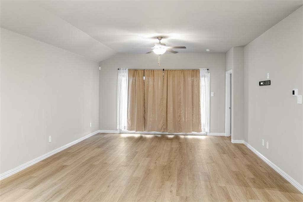 614 Martell Road, Lowry Crossing, TX 75069 Vaulted ceilings featuring a central ceiling fan, wood-finish flooring, and glass sliding doors