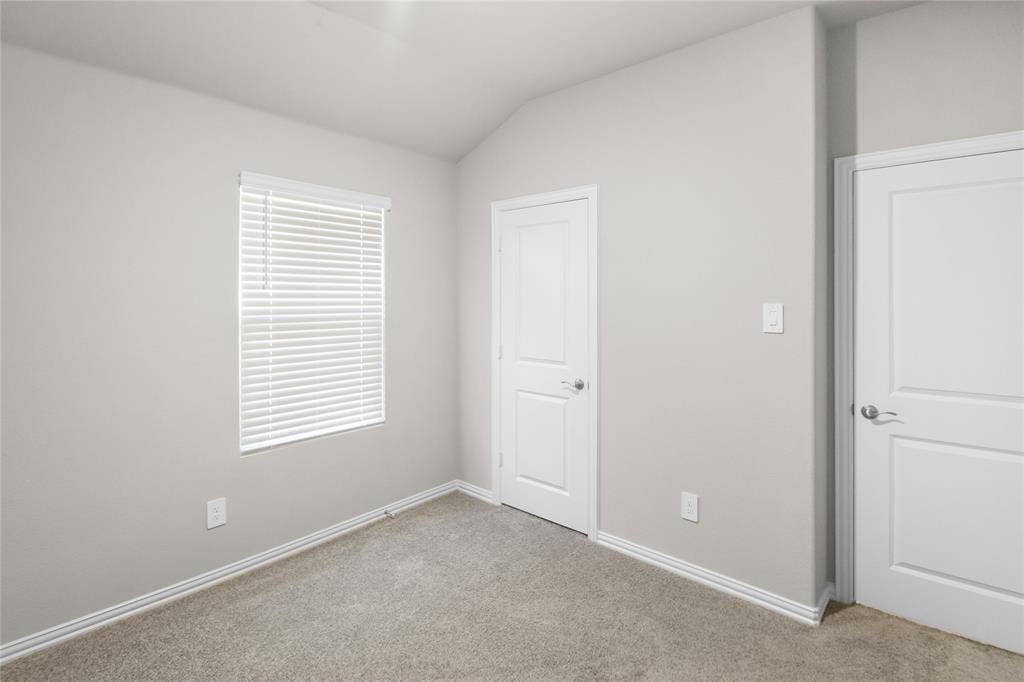614 Martell Road, Lowry Crossing, TX 75069 Neutral interior featuring high vaulted ceilings, wall-to-wall carpeting, two panel-style doors, and a window with horizontal blinds