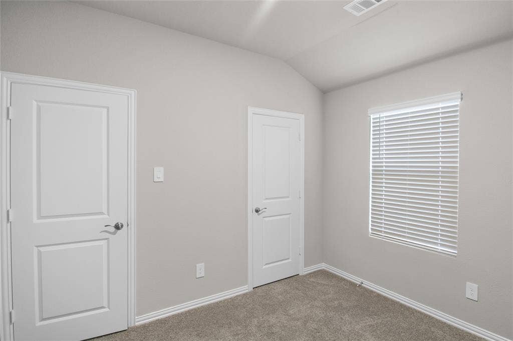 614 Martell Road, Lowry Crossing, TX 75069 Vaulted ceiling, neutral wall tones, interior two-panel doors, and horizontal slat window blinds