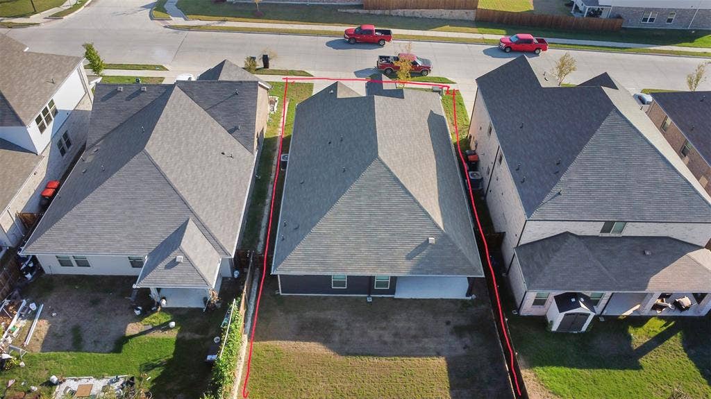 614 Martell Road, Lowry Crossing, TX 75069 Aerial perspective of a detached residential property featuring a hipped roof, covered rear patio, and a fenced backyard