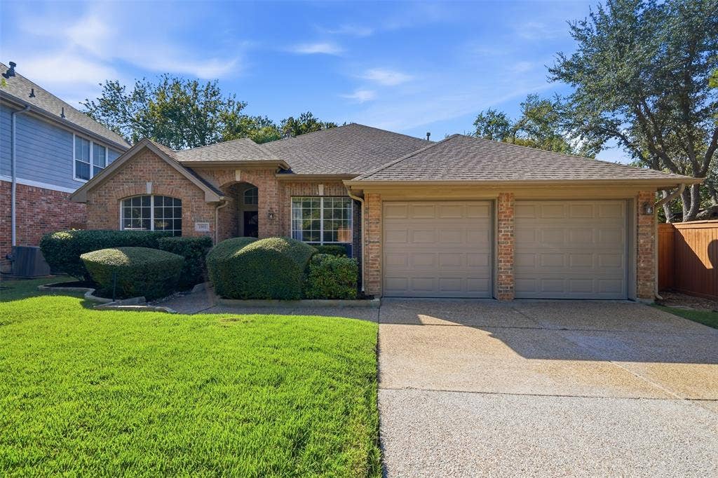 2902 Glen Hollow Court, McKinney, TX 75072 Mature landscaping with a pebble texture drive way and two brand new garage doors