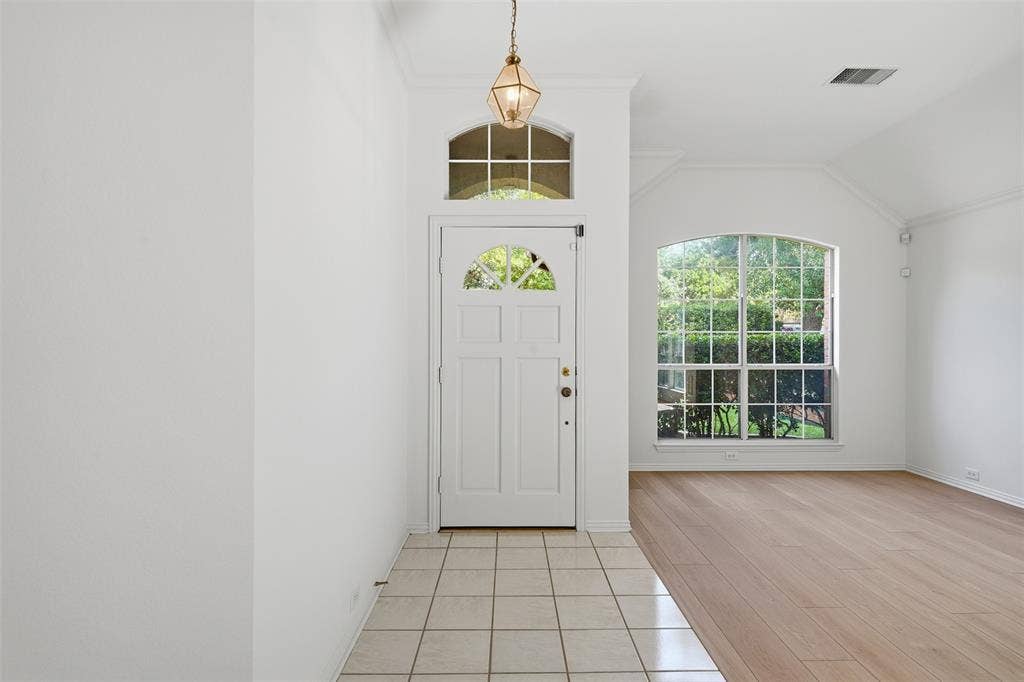 2902 Glen Hollow Court, McKinney, TX 75072 Entryway leads to stacked formals with arched windows and new vinyl plank flooring.
