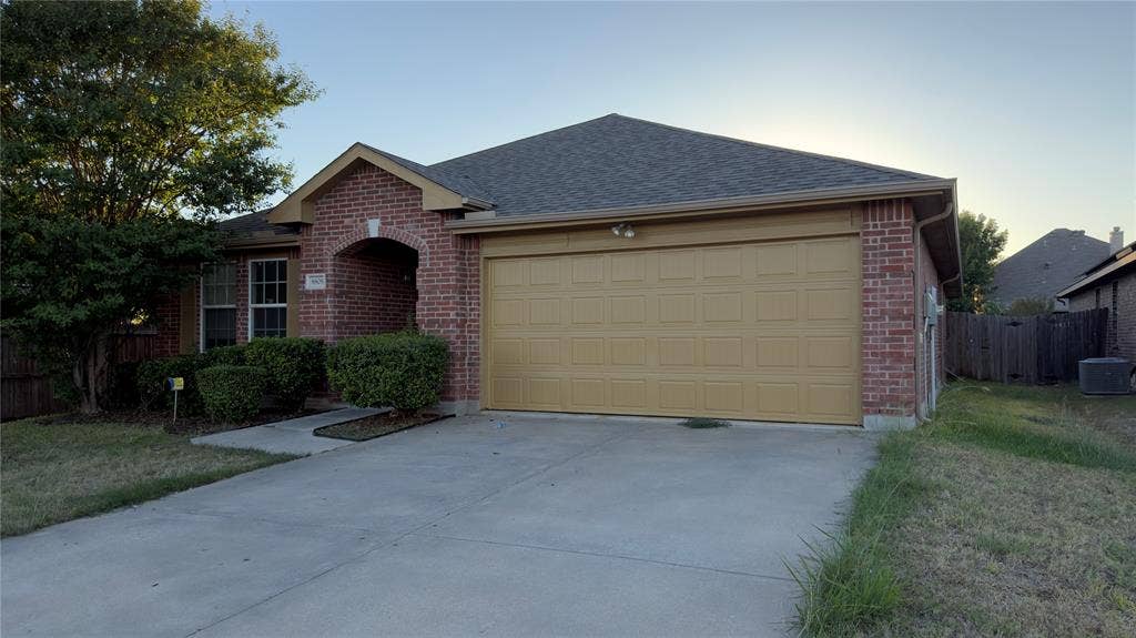 8808 Irish Bend Drive, Fort Worth, TX 76123 Brick exterior featuring a gabled roofline, recessed entryway, and a two-car garage