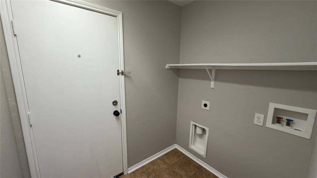 8808 Irish Bend Drive, Fort Worth, TX 76123 Utility area featuring neutral wall paint, tiled flooring, an installed shelf, and dedicated water and electrical hookups