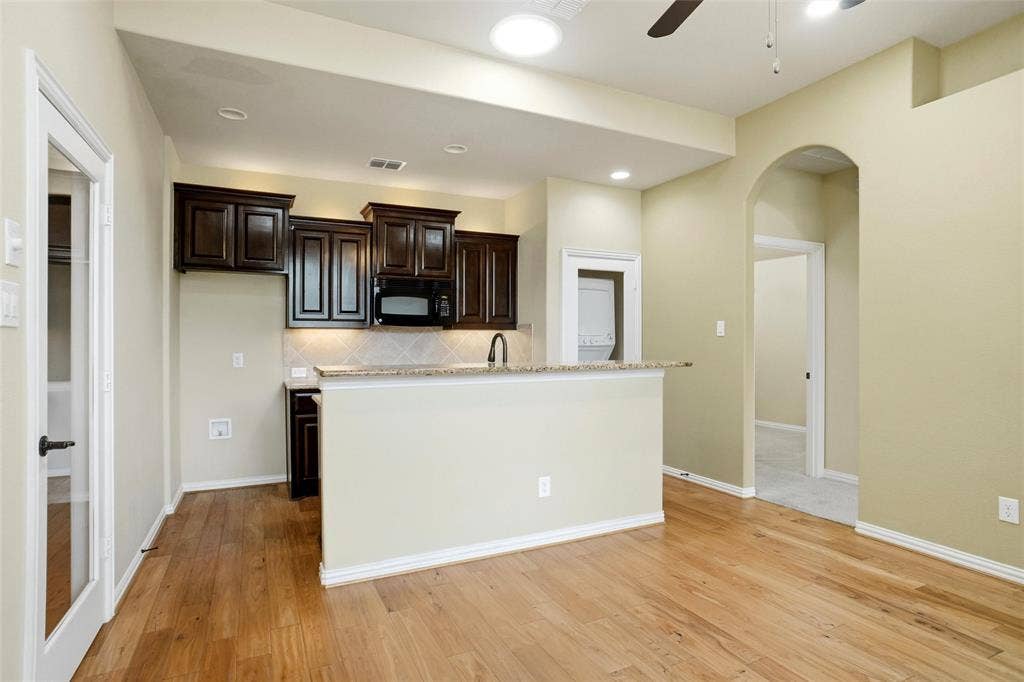 8301 Rock Valley Drive, Rowlett, TX 75089 In-Law Suite kitchen with stackable washer and dryer, microwave.
