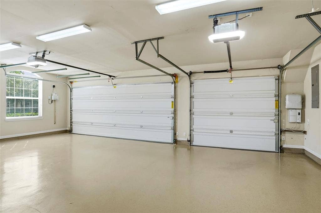 8301 Rock Valley Drive, Rowlett, TX 75089 3 car garage with epoxy coated flooring.