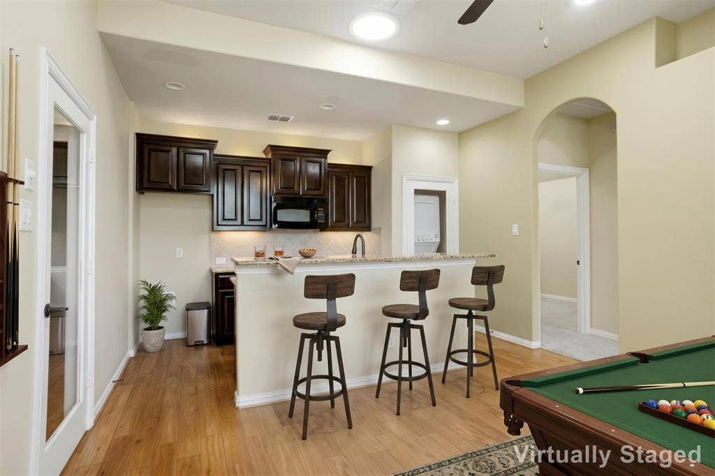 8301 Rock Valley Drive, Rowlett, TX 75089 VIRTUALLY STAGED IN LAW SUITE KITCHEN AS A GAMEROOM