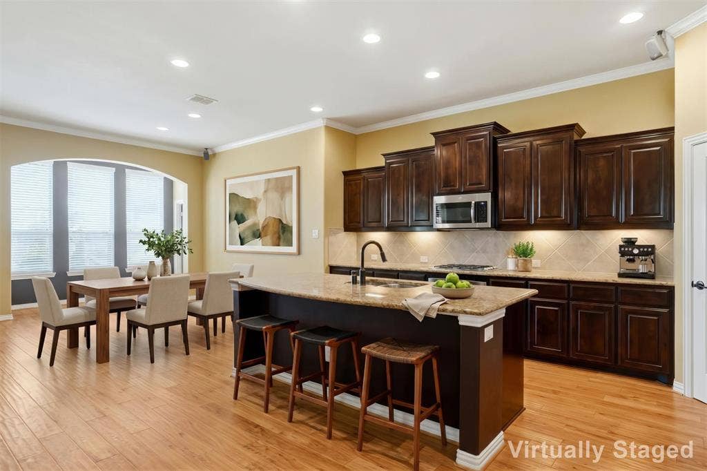 8301 Rock Valley Drive, Rowlett, TX 75089 VIRTUALLY STAGED KITCHEN DINING AREA.