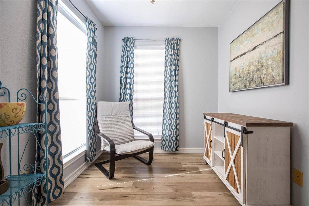 Interior space featuring wood-finish flooring and dual tall windows