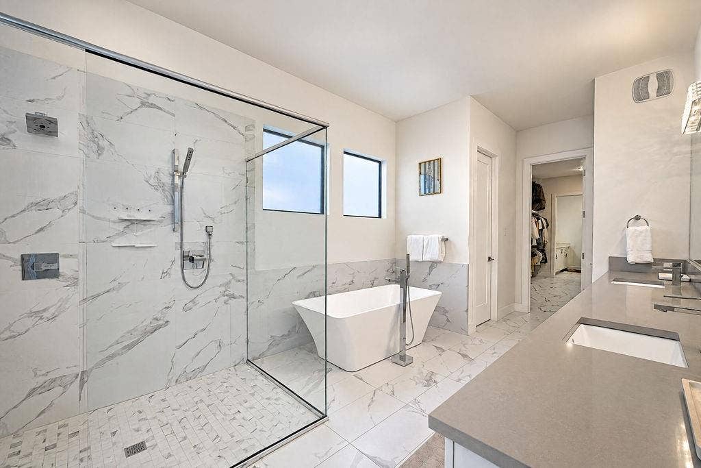 4515 Cowan Avenue, Dallas, TX 75209 The spa-inspired primary bath features a standalone soaking tub and a spacious walk-in shower for ultimate evening unwind time