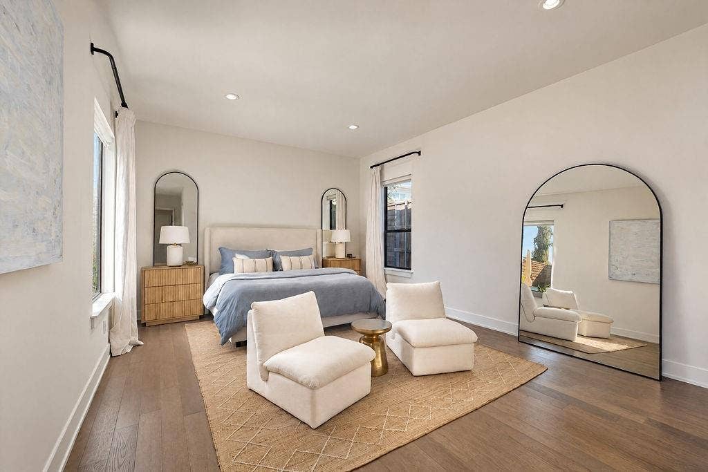 4515 Cowan Avenue, Dallas, TX 75209 The main-floor primary suite offers room for a king bed and a cozy reading chair, wrapped in rich hardwood flooring