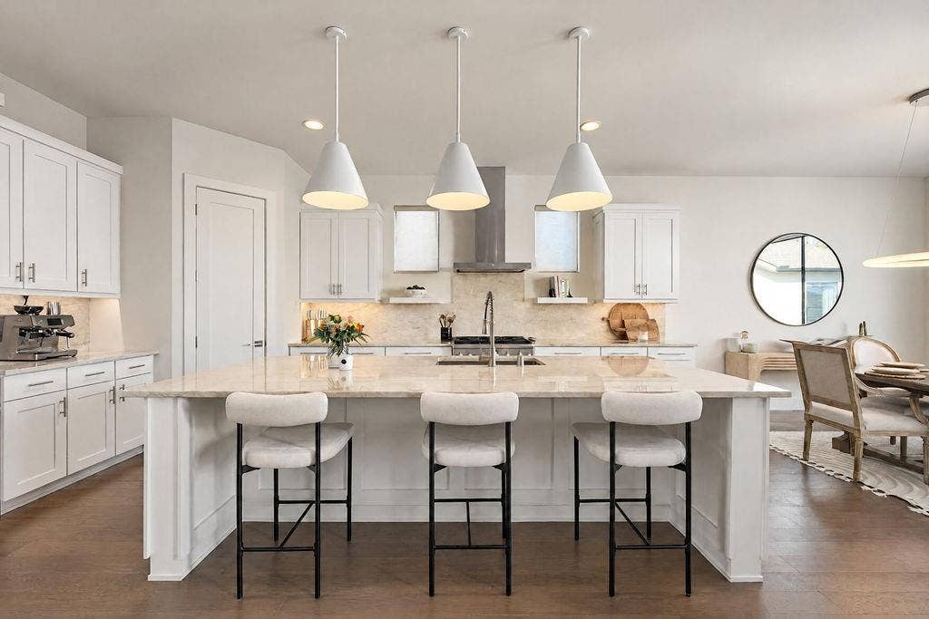 4515 Cowan Avenue, Dallas, TX 75209 High-end pendant lights cast a soft glow over quartz countertops, pairing everyday practicality with effortless prep space
