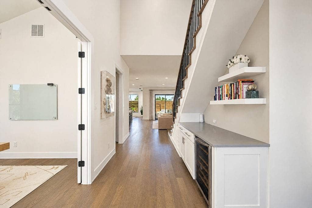 4515 Cowan Avenue, Dallas, TX 75209 Step into a welcoming hallway where built-in wine storage under the staircase keeps your collection organized right near the front door