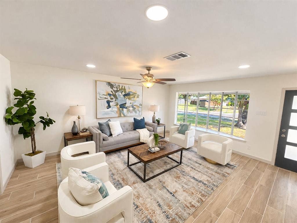 2551 Pinebluff Drive, Dallas, TX 75228 Living area featuring wood-finish tile flooring, recessed lighting, a ceiling fan with integrated light fixture, a large picture window, and a modern glass-paneled entry door