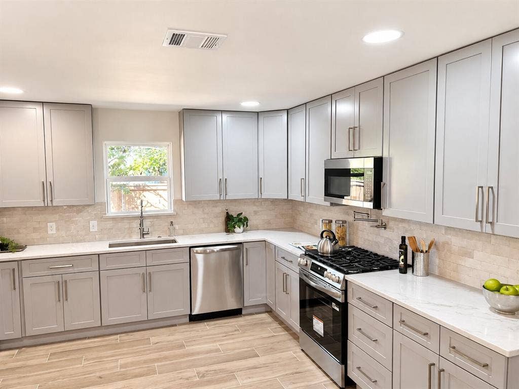 2551 Pinebluff Drive, Dallas, TX 75228 Kitchen featuring shaker-style cabinetry, stone-finish backsplash, stainless steel appliances, quartz countertops, and wood-finish flooring