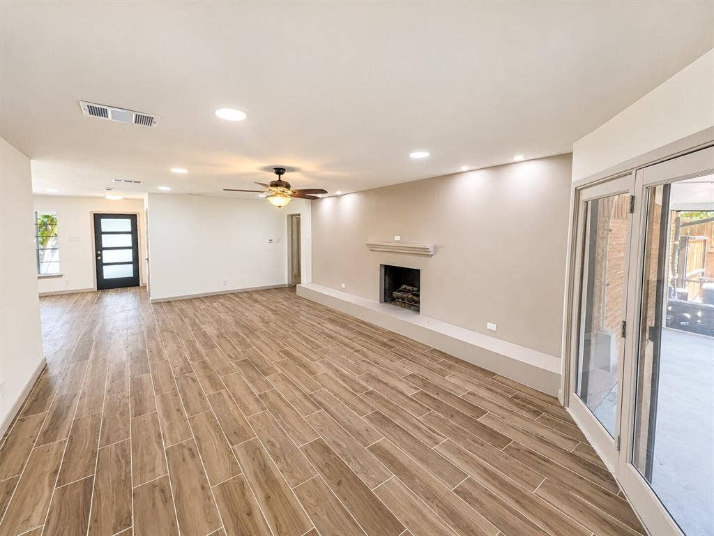 2551 Pinebluff Drive, Dallas, TX 75228 Interior featuring wood-finish tile flooring, a fireplace with a concrete hearth, recessed ceiling lighting, a ceiling fan, and sliding glass patio doors