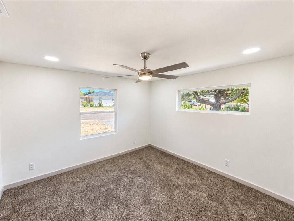 2551 Pinebluff Drive, Dallas, TX 75228 Room featuring neutral wall-to-wall carpeting, recessed ceiling lighting, a brushed-nickel finish ceiling fan, and dual window configurations