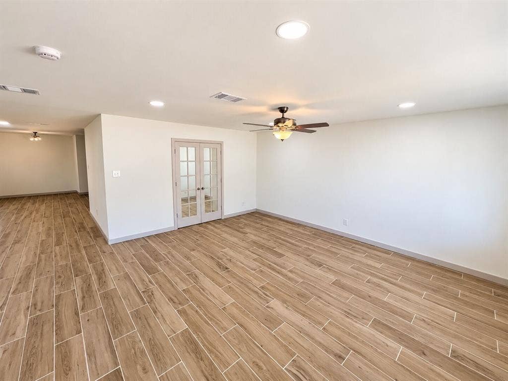 2551 Pinebluff Drive, Dallas, TX 75228 Open interior space featuring wood-finish flooring, recessed lighting, ceiling fans, and French doors