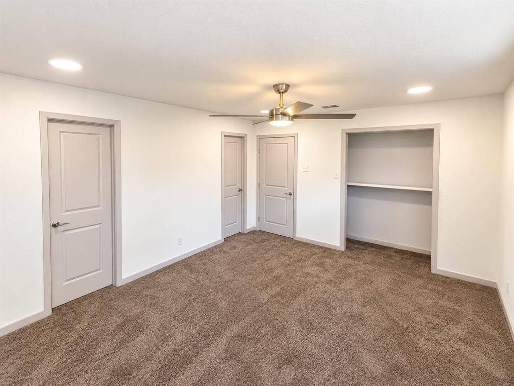 2551 Pinebluff Drive, Dallas, TX 75228 Interior space featuring neutral wall tones, wall-to-wall carpeting, a ceiling-mounted light fixture with fan, recessed lighting, and a built-in closet with shelving