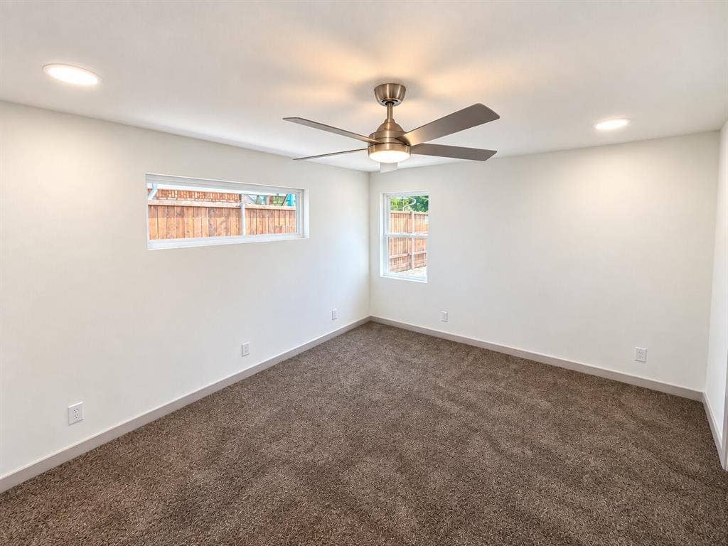 2551 Pinebluff Drive, Dallas, TX 75228 Neutral-toned carpeting, brushed nickel ceiling fan with integrated lighting, recessed ceiling lighting, and dual vinyl-framed windows