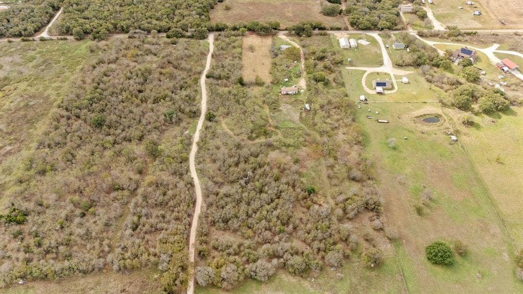 870 Wagoner Road, Waco, TX 76705 Expansive acreage featuring mature trees, natural vegetation, and an existing dirt access path