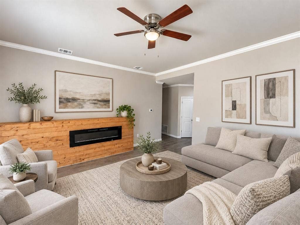 1306 Campbelton Drive, Temple, TX 76504 Living area featuring a horizontal electric fireplace, wood-plank accent wall, crown molding, and a central ceiling fan