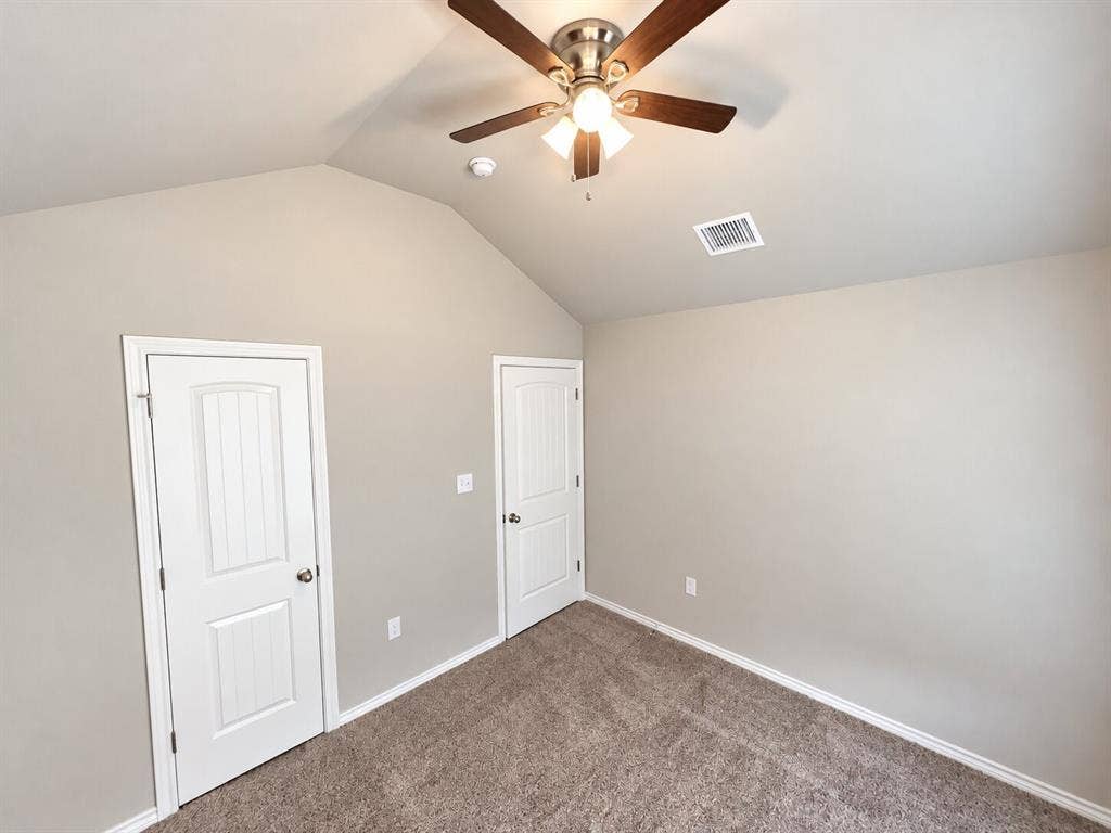 1306 Campbelton Drive, Temple, TX 76504 Vaulted ceilings featuring a brushed nickel ceiling fan with integrated lighting, neutral wall finishes, plush wall-to-wall carpeting, and two-panel interior doors