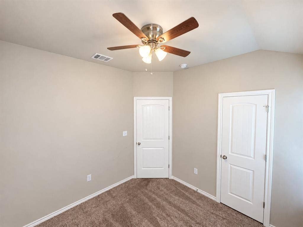 1306 Campbelton Drive, Temple, TX 76504 Room featuring neutral wall tones, wall-to-wall carpeting, vaulted ceiling, multi-blade ceiling fan with integrated lighting, and two-panel interior doors