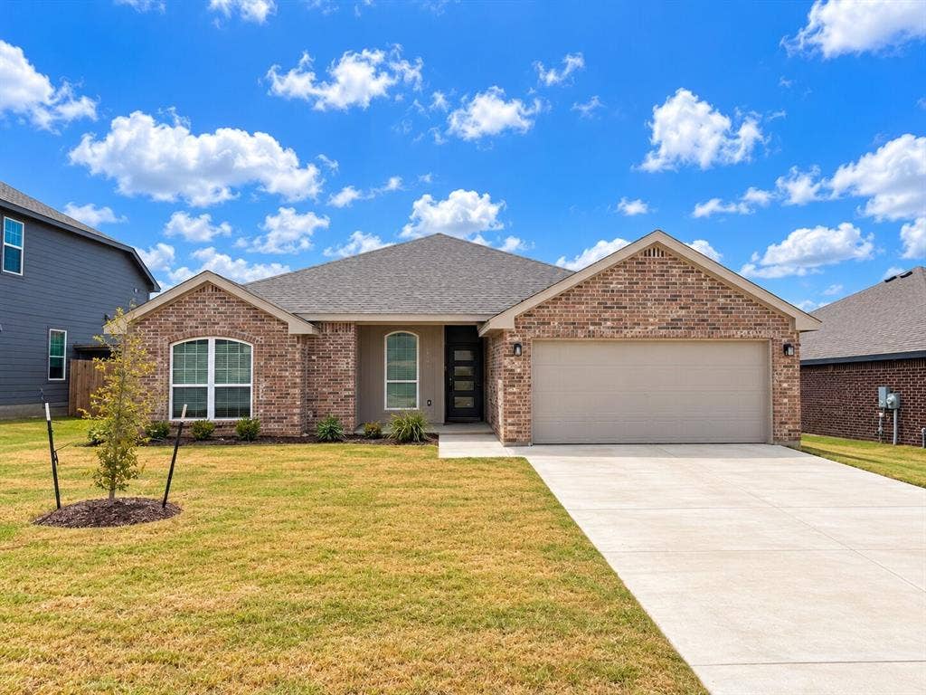 1306 Campbelton Drive, Temple, TX 76504 Single-story brick exterior featuring a multi-gabled roofline, arched window detailing, and an attached two-car garage with a concrete driveway
