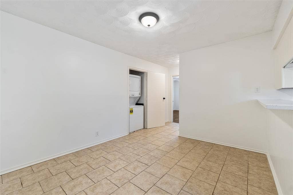 11038 Wyatt, Dallas, TX 75218 Tile flooring, white walls, and a dedicated closet housing a stacked washer and dryer