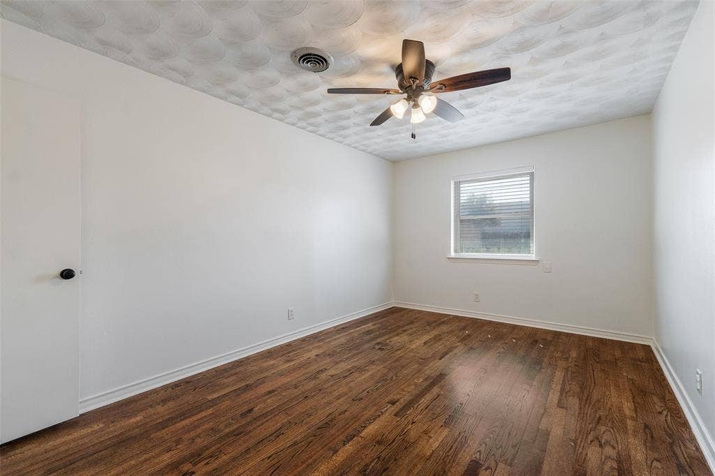 11038 Wyatt, Dallas, TX 75218 Interior space featuring wood-finish flooring, a ceiling fan with integrated lighting, and a window with blinds