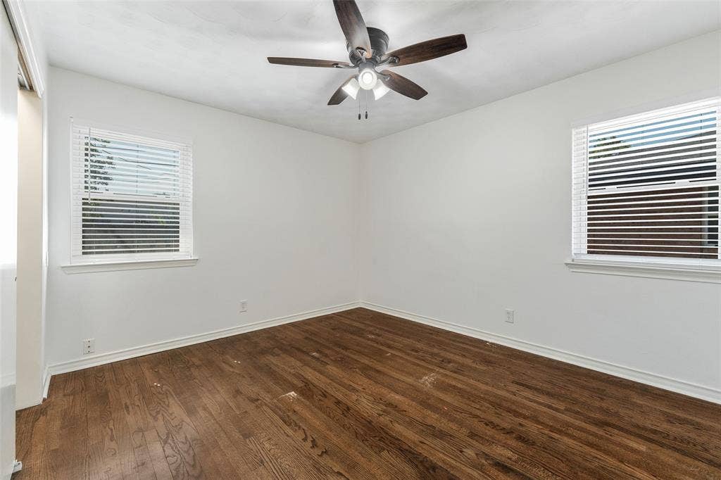 11038 Wyatt, Dallas, TX 75218 Wood-finish flooring, dual windows with horizontal blinds, and a central ceiling fan with integrated lighting