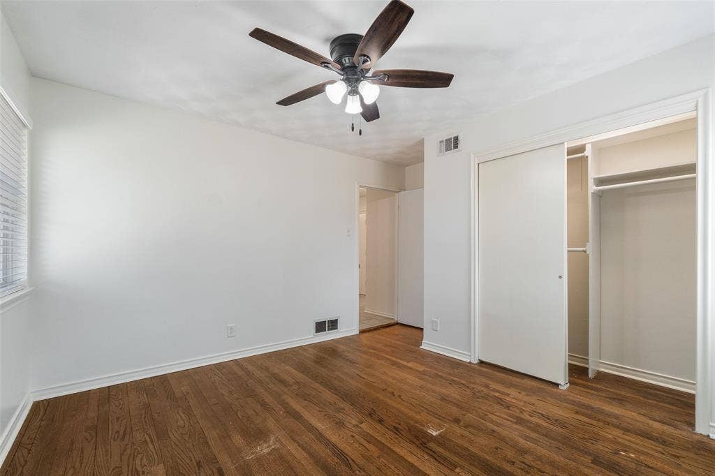 11038 Wyatt, Dallas, TX 75218 Wood-finish flooring, ceiling fan with integrated lighting, and closet with sliding doors