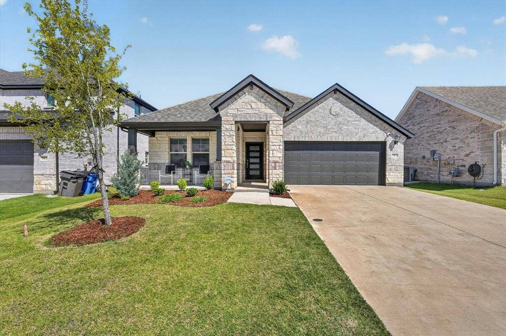 903 Edgehurst Drive, Princeton, TX 75071 Contemporary single-story residence featuring a stone and brick exterior with dark trim