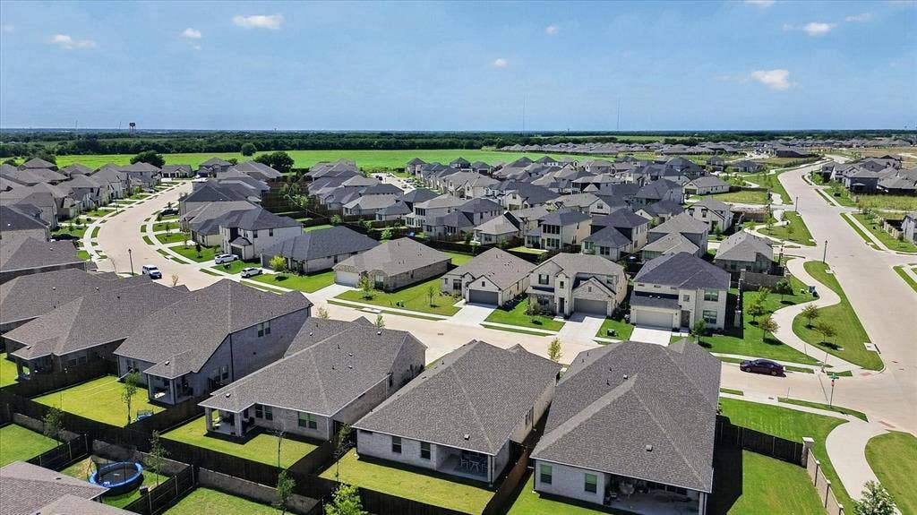 903 Edgehurst Drive, Princeton, TX 75071 Residential neighborhood featuring numerous single-family homes with gray shingle roofs, manicured lawns, and paved roads