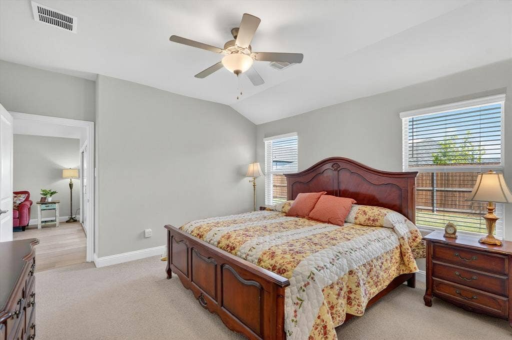 903 Edgehurst Drive, Princeton, TX 75071 Carpeted room with vaulted ceiling and a ceiling fan with integrated lighting
