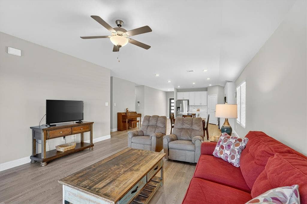 903 Edgehurst Drive, Princeton, TX 75071 Open-concept living area featuring wood-finish flooring, recessed lighting, and a ceiling fan with integrated lighting