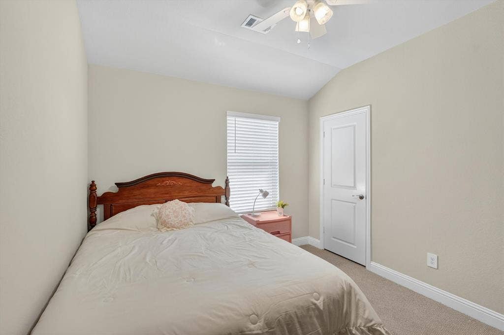 903 Edgehurst Drive, Princeton, TX 75071 Carpeted room featuring a vaulted ceiling and a ceiling fan with integrated lighting