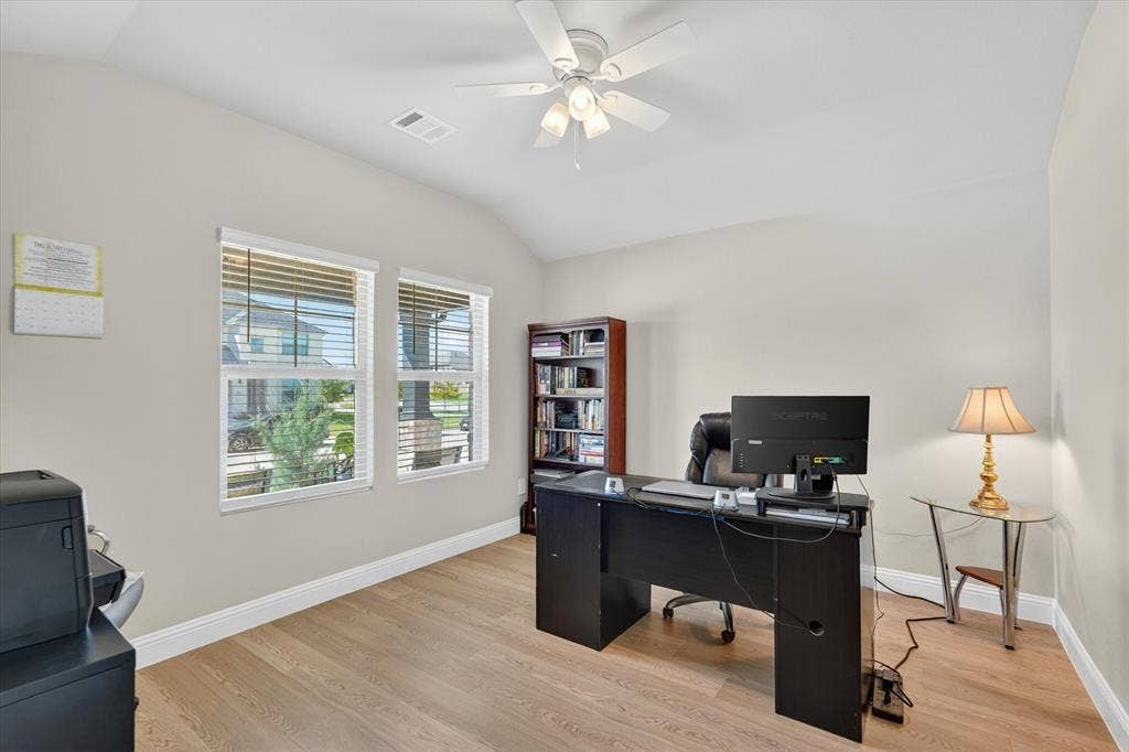 903 Edgehurst Drive, Princeton, TX 75071 Spacious room featuring wood-finish flooring, vaulted ceilings, and a ceiling fan with integrated lighting