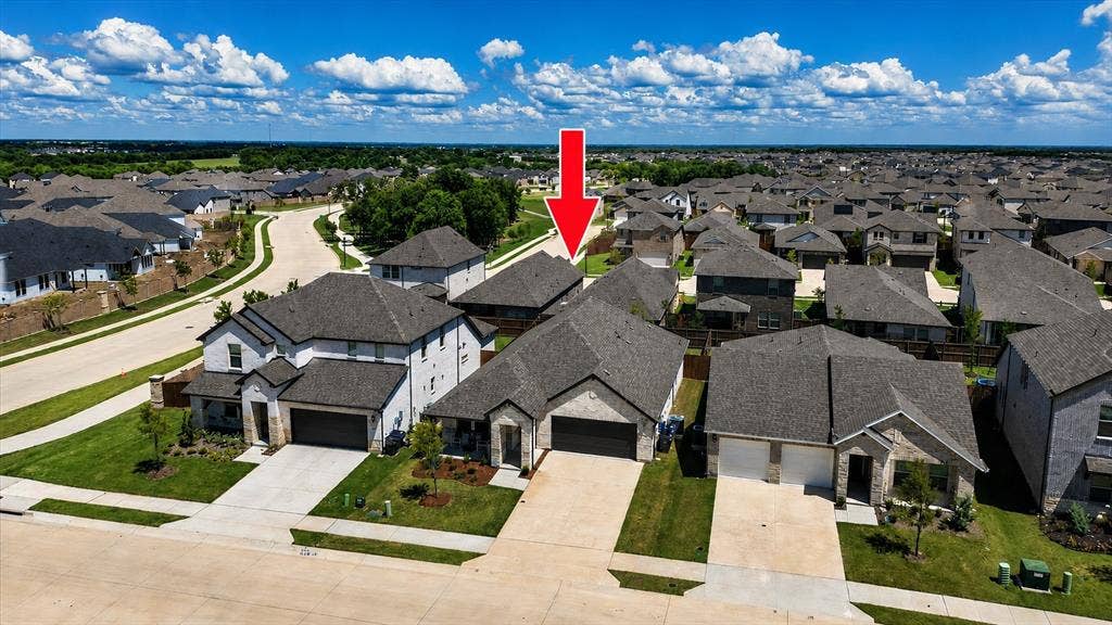 903 Edgehurst Drive, Princeton, TX 75071 Single-story residence featuring a stone and siding exterior, an attached two-car garage, and a covered entryway